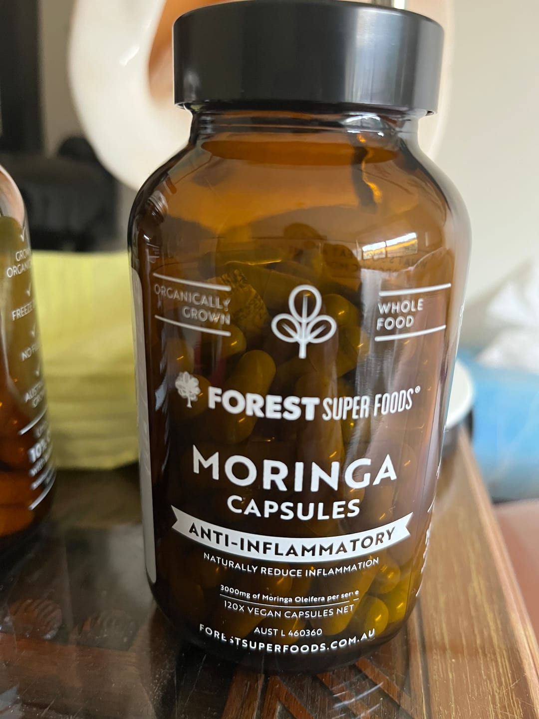 Close-up of a Forest Super Foods Moringa capsules bottle, organically grown and marketed for moringa benefits such as reduced inflammation, better digestion, and improved energy.